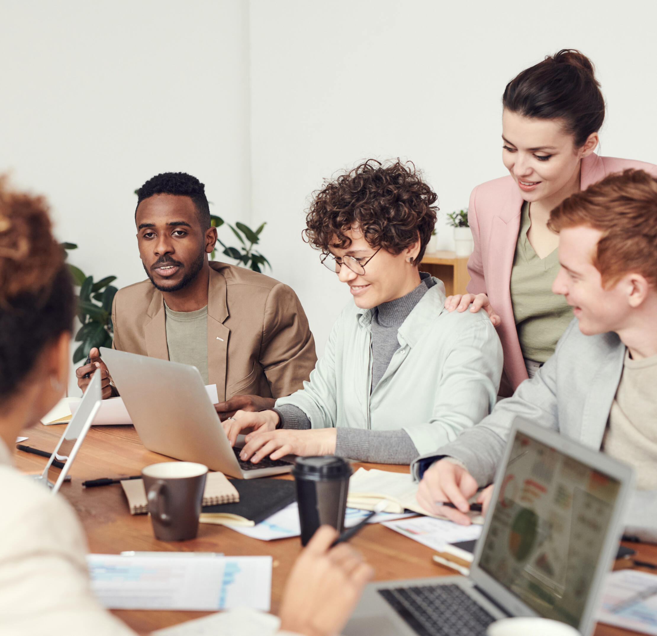 a group of people happily engaged in meeting, as if they were using MeetingFusion
